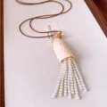 Detail shot of pearl tassel necklace with leather cord and natural shell pendant - Coffee-White