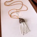 Detailed view of pearl tassel necklace with wooden shell pendant and brown braided cord - Coffee-Gray-White
