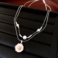 Close-up detail of double-layer necklace with daisy pendant and white pearls - Double Daisy Pendant Style / Silver (Gold Flower Core)
