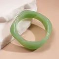 Detailed macro view of a translucent light green chunky resin bracelet on stone - Style 21