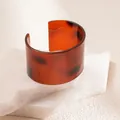 Detailed macro view of a wide tortoiseshell open cuff bracelet with rich amber resin texture - Tortoiseshell Pattern Style (31# Bangle)