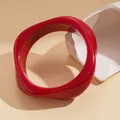 Close-up of a glossy red wavy bangle with organic modern design on neutral background - Wavy Edge Style (36# Bangle)