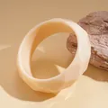 Close-up of a cream-colored faceted geometric resin bangle on a warm-toned surface - Geometric Faceted Style (40# Bangle)