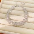 Détail d'un bracelet en maille tissée avec perles de verre sur un plateau à bijoux - Argent-Transparent