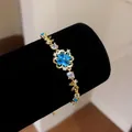 Close-up of blue zircon flower bracelet with sparkling heart petals on black velvet - Style 3