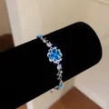 Detailed macro view of an elegant flower bracelet with sparkling blue zircons - Style 4