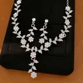 Close-up of elegant silver-colored floral leaf necklace and earrings with rhinestones - Necklace and Earrings Set / Silver