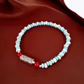 Close-up of ethnic beaded bracelet featuring turquoise beads and engraved silver tube. - Ethnic Beaded Style / Exquisite Gift Box / Blue White