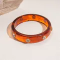 Elegant amber resin bangle with embedded sparkling crystal rivets for a luxury look. - 65# Bangle (65#)