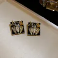 Close-up of vintage black drip oil butterfly stud earrings with sparkling crystals - Butterfly Stud Earrings / 1 Pair (2.5x2.5cm) / Gold-Black