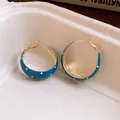 Detail view showing vintage teal enamel hoop earrings with stylish white polka dots - Blue Polka Dot / Gold