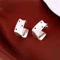 Detailed view of minimalist brushed silver square stud earrings with black polka dots - Square Polka Dot Brushed Style / Silver