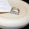 Close-up of minimalist silver square open ring with zircon and shell inlay details. - Silver