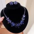 Close-up of elegant blue floral crystal necklace and earrings set on black velvet stand - Earrings Necklace Set / Purple