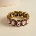 Detail view of a vintage pink square crystal elastic bracelet in a gold setting. - Gold-Pink