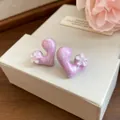 Detailed close-up showing the texture of purple marble heart earrings with resin flowers - Purple