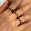 Close-up of three bohemian elastic rings with gold beads and tiger eye stones on hand - 虎眼石波西米亚三件套(K-127) / Gold & Brown