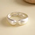 Macro detail of silver matte textured cuff bangle with hinged geometric design - Loose Fit