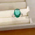 Detailed close-up of a silver ring featuring a stunning oval green zircon center stone - Ring / Silver-Green