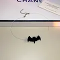 Detailed view of Halloween black bat pendant on a transparent invisible choker chain - Necklace-Black-Bat