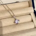 Elegant purple zircon geometric pendant necklace displayed in a beige luxury jewelry box. - Necklace / Purple