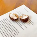 Detail view of French retro dark brown hoop earrings with white polka dot pattern - Gold Brown