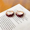 Macro view of French retro dark red hoop earrings with elegant white polka dot pattern - Gold-Red