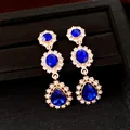 Elegante vintage gouden hangende oorbellen met koningsblauwe waterdruppel kristallen - Zilveren oorknopje - Goud - Blauw