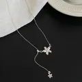 Detailed view of a silver flower pendant necklace with a delicate Y-shaped chain design. - Flower Pendant Necklace (Silver)