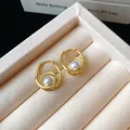 Close-up detail of French vintage style gold hoop earrings with elegant white pearl drops - Gold