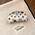 Detail view of a cream-colored hair claw clip featuring blue and brown polka dot patterns. - Half Moon Arc Style (Type 3) / Blue Coffee Polka Dot
