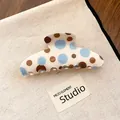 Detailed view of cream claw clip with blue and brown polka dots on a canvas background - Medium Rounded Style (Type 2) / Blue Coffee Polka Dot
