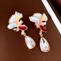 Detailed macro of colorful fan-shaped earrings with clear teardrop crystals - Fan Water Drop Style / Gold/Multicolor