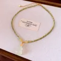 Close-up of double-layered beaded necklace with a light green jadeite gourd pendant - Gold Plated Chalcedony Gourd Style / Gold-Green