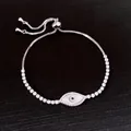 Detailed macro view of an elegant zircon shell evil eye drawstring bracelet for women - Silver