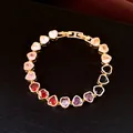 Detail view of heart-shaped zircon bracelet with 18k gold plating and secure folding clasp - Gold-Multicolor