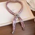 Detailed view of a pink leopard fabric necklace with a silver resin flower slider. - Silver-Pink
