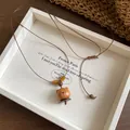 Detail view of the hand-carved wooden bear pendant on an adjustable cord - Necklace-Brown-Bear