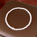 Detailed view of an elegant French-style pearl bracelet with a sparkling zircon flower bead. - Silver
