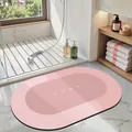 Pink oval absorbent bathroom mat with HOME text in a modern bathroom setting decor - 40*60cm / Oval / Light Pink
