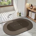 Oval non-slip brown diatomaceous earth bath mat with 'HOME' text in a bathroom scene. - 40*60cm / Oval / Dark Brown