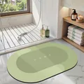 Modern green oval diatom mud absorbent bath mat featuring minimalist white HOME text detail - 40*60cm / Oval / Yellow-Green