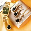 Gros plan d'une élégante montre à quartz dorée pour femme avec parure de bijoux en pierre noire - Parure de bijoux dorée avec pierres vertes en forme de poire