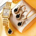 Vue détaillée d'une montre à quartz carrée dorée et d'une parure de bijoux noire - Parure de bijoux dorée avec pierres noires en forme de poire