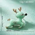 Elegant light green reindeer brooch with gold accents and snowflake design for Christmas - Running Reindeer Style (98)