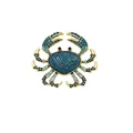 Elegant gold-toned crab brooch encrusted with sparkling blue and aqua rhinestones on white background - Blue