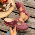 Close-up detail showing the intricate hollow flower pattern on burgundy platform mules - 36 / Burgundy