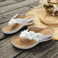 White wedge flip-flops for women featuring elegant floral appliques on a summer deck - 36 / White