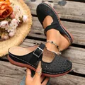 Detailed view of black laser-cut hollow wedge slippers with adjustable buckle strap - 36 / Black