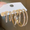 Set of three pairs of sparkling gold-tone hoop earrings with shiny clear rhinestones - Large Medium Small Hoops 3 Pairs Set (5604402HB) / Gold